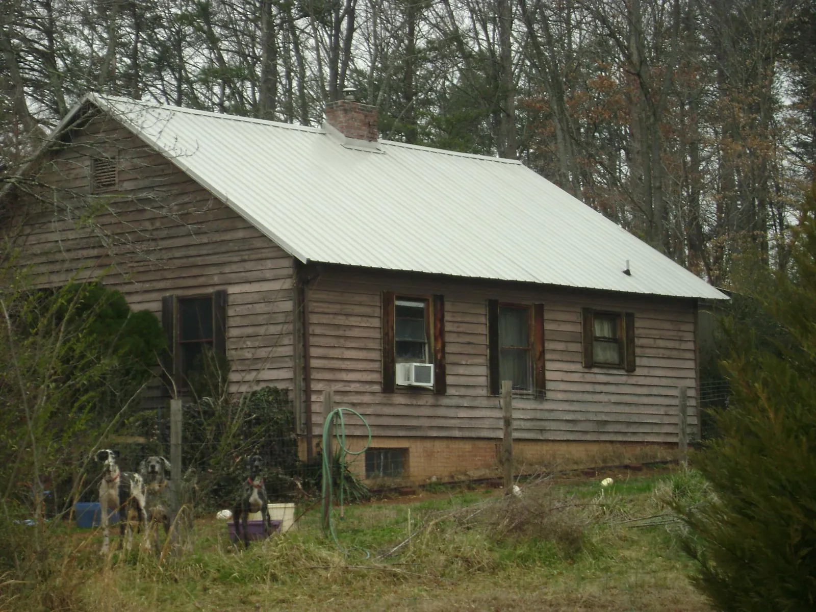 White metal roof on an old wood sided farmhouse, from a Metal Roof Installation job in Fort Dodge